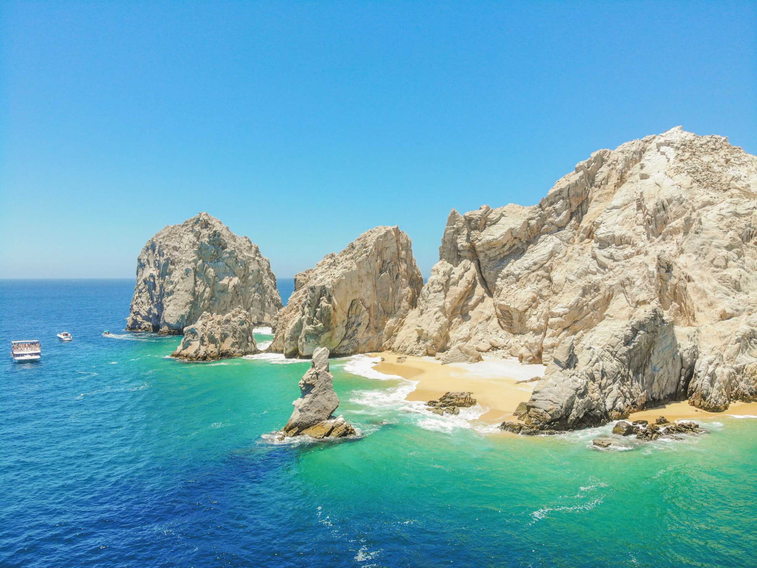 A breathtaking aerial view of El Arco in Cabo San Lucas with turquoise waters and rocky formations.